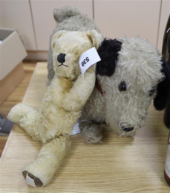 A large English terrier dog and a Chad Valley bear